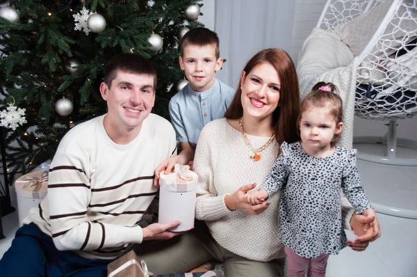 Family, parents and two children, boy and a girl, near a Christmas tree — Stock Photo, Image