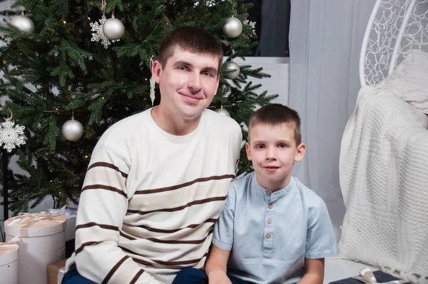 Dad and son boy near a Christmas tree — Stock Photo, Image