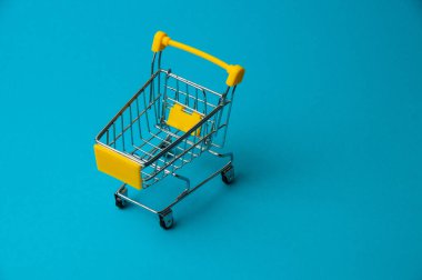 Mavi arka planda alışveriş için tramvay. Süpermarket fiyat konsepti, tatil indirimleri