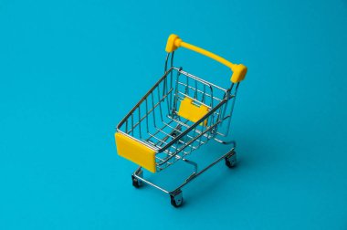 Mavi arka planda alışveriş için tramvay. Süpermarket fiyat konsepti, tatil indirimleri