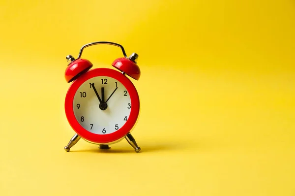 Sarı arkaplanda klasik alarm saati kırmızı