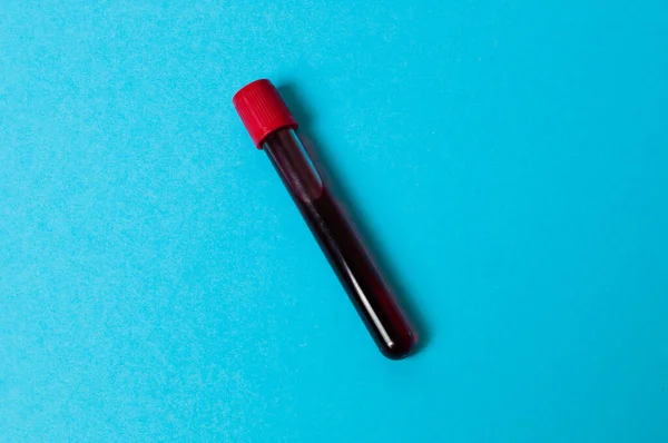 stock image Test tube with blood isolate on blue background