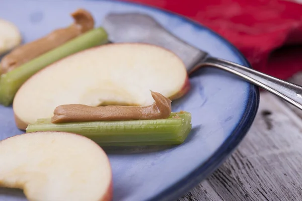 Apples and celery with peanut butter. — Stock Photo, Image