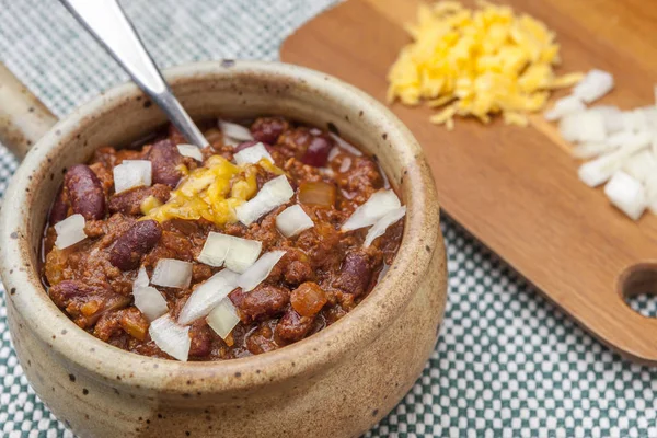 Spoon in delicious bowl of chili. — Stock Photo, Image