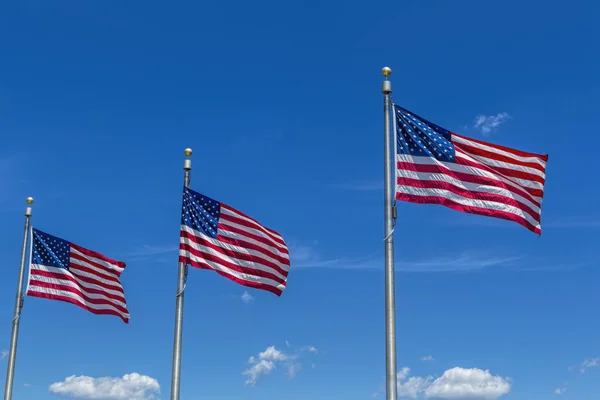 Three US flags and bright blue sky. — Stock Photo, Image