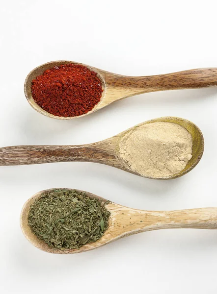 Overview of spices in wooden spoons. — Stock Photo, Image
