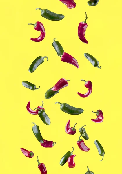 Peppers set against a yellow background. — Stock Photo, Image