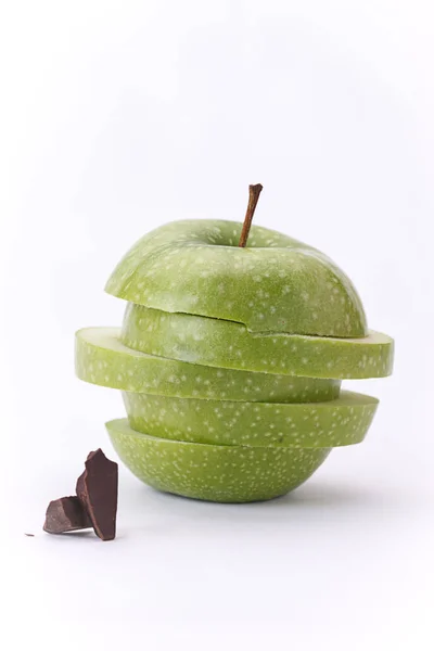 Chocolate chunks by green apple. — Stock Photo, Image
