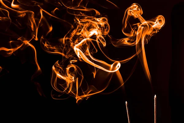 Orange incense smoke floating around. — Stock Photo, Image