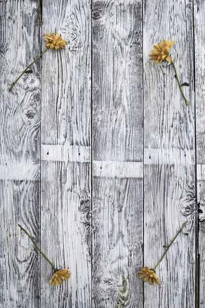 Weathered wood frame with flowers.
