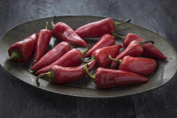 Red peppers on a platter. — Stock Photo, Image