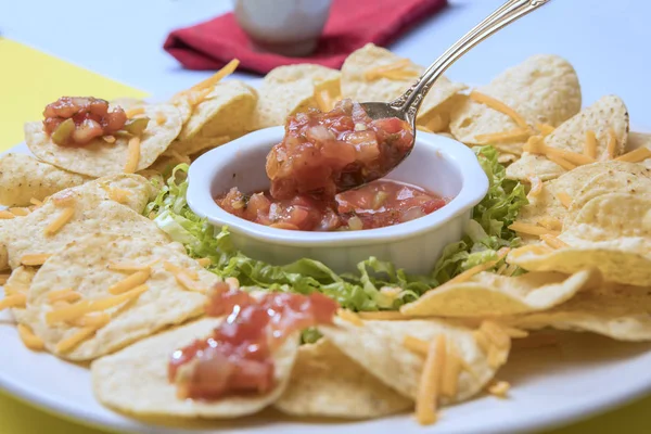 Focus on spoon with salsa. — Stock Photo, Image