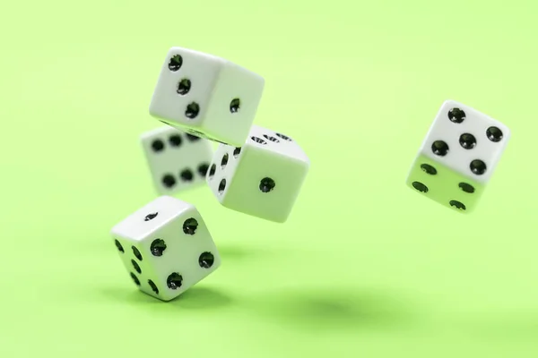 Dice being rolled on a green table. A conceptual photo of dice being rolled on a green table.