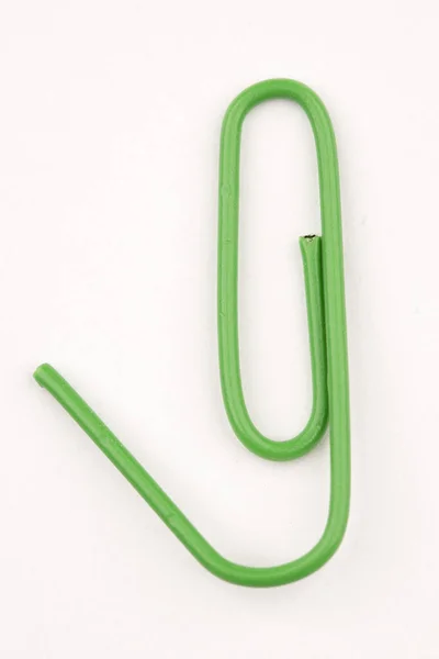 Concept Photo Closeup Green Plastic Coated Paper Clip Bent — Stock Photo, Image