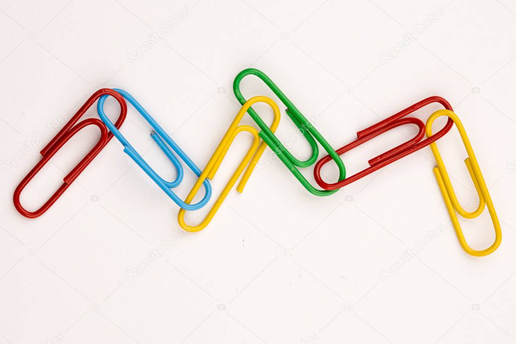 A concept photo of a wavy link of multi-colored paperclips.