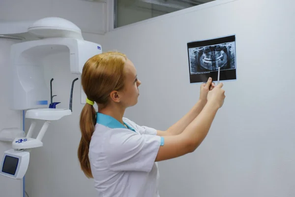 dentist analyzes a dental panoramic x-ray film