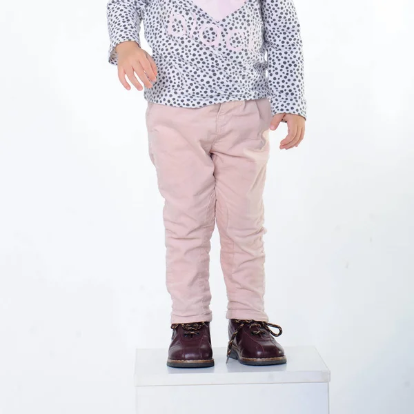 Child legs wearing shoes on a white background — Stock Photo, Image