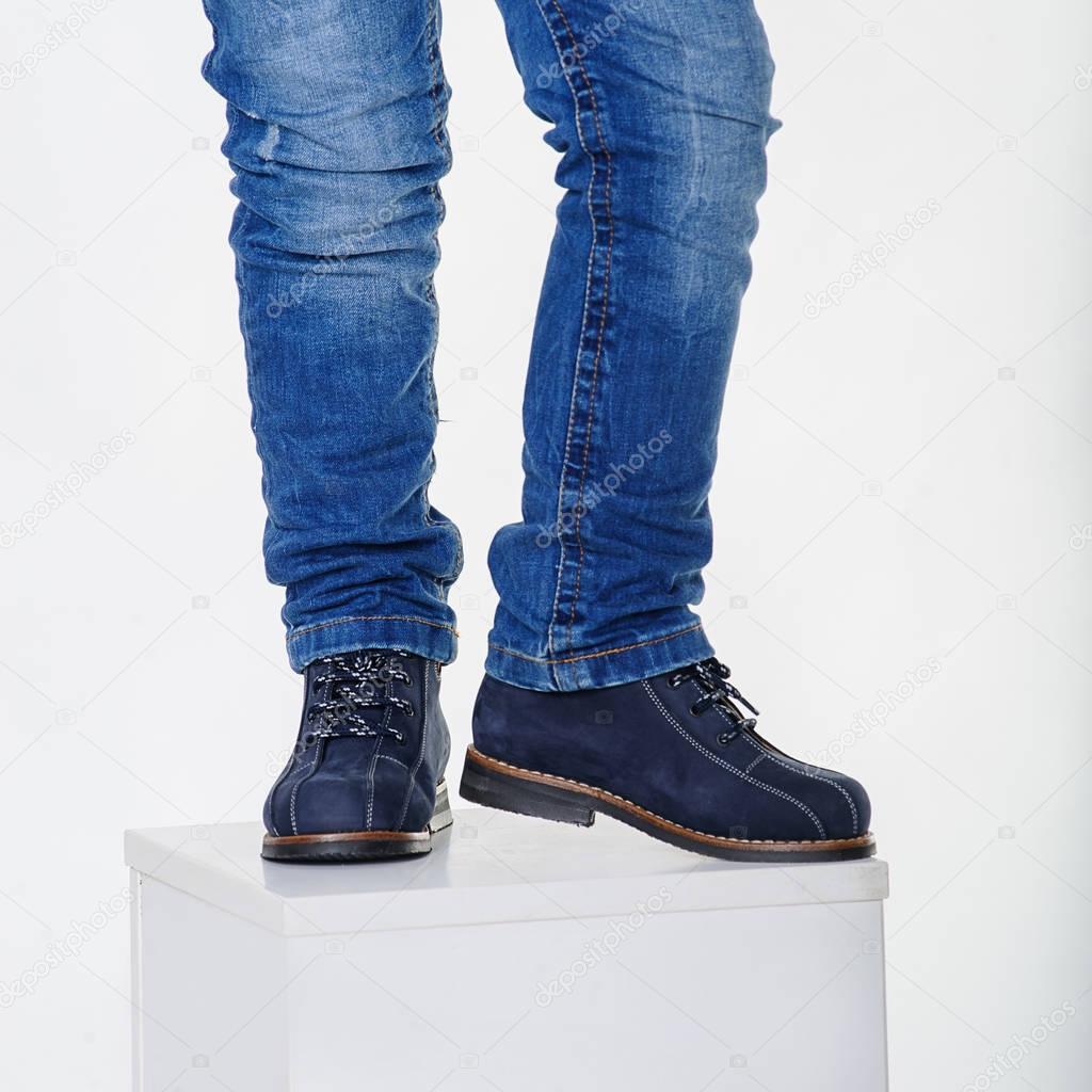 Child legs wearing shoes on a white background 