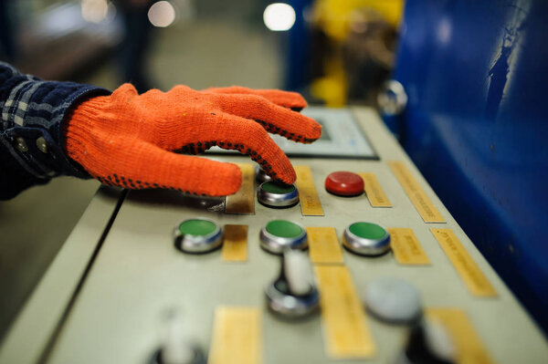 рука оператора на металлообрабатывающей машине
