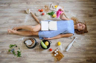 desperate housewife lying on the floor in her kitchen clipart