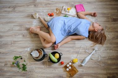 desperate housewife lying on the floor in her kitchen clipart