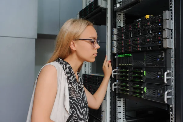 Young woman engineer It technician in the data center server roo