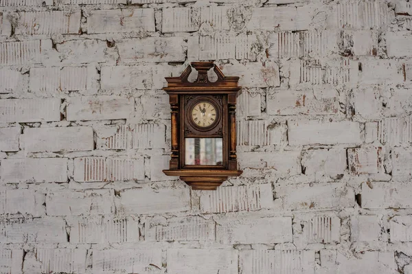 Old Vintage wood clock on the brick wall