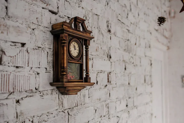 Old Vintage wood clock on the brick wall