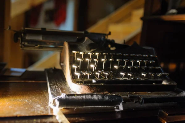 vintage typewriter on the desk full of cobweb