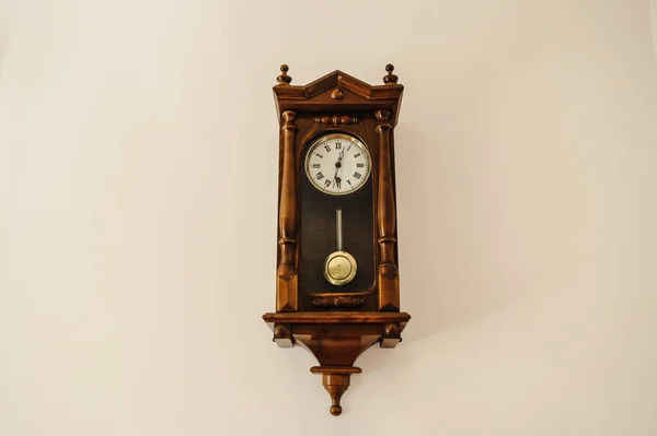 Antique wall clock with a pendulum from wood — Stock Photo, Image
