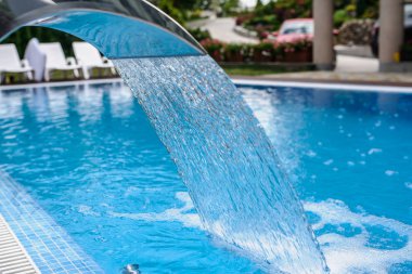 View of a empty swimming pool with blue wa