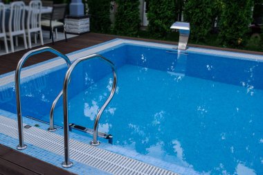 View of a empty swimming pool with blue wa