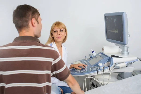 Ultrasunografia medico sta spiegando al paziente a divice — Foto Stock