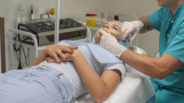 Top view of chin augmentation procedure on a young woman done by a cosmetologist doctor with Hyaluronic acid Injection.