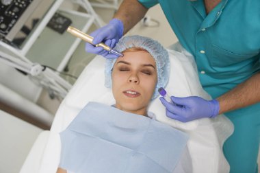 Closeup of a woman recieving microdermabrasion procedure on the elbow