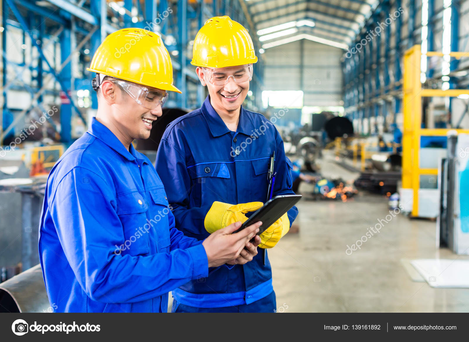 Two workers in production plant as team Stock Photo by ©Kzenon 139161892