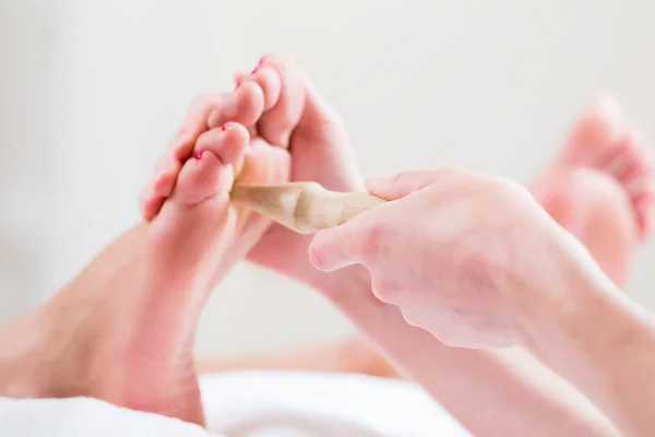 Women at reflexology having foot massaged — Stock Photo, Image