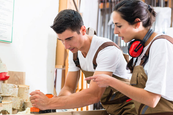 woman and man working together