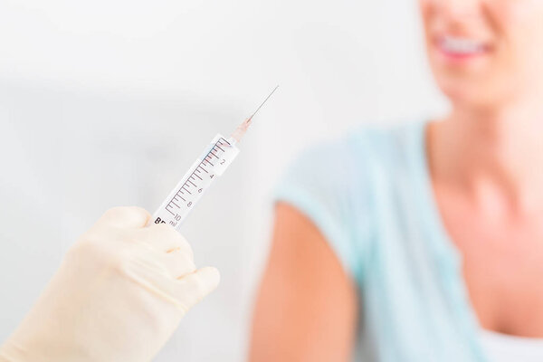 Doctor preparing syringe