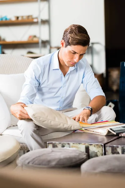 Man choosing colors and material for furniture — Stock Photo, Image