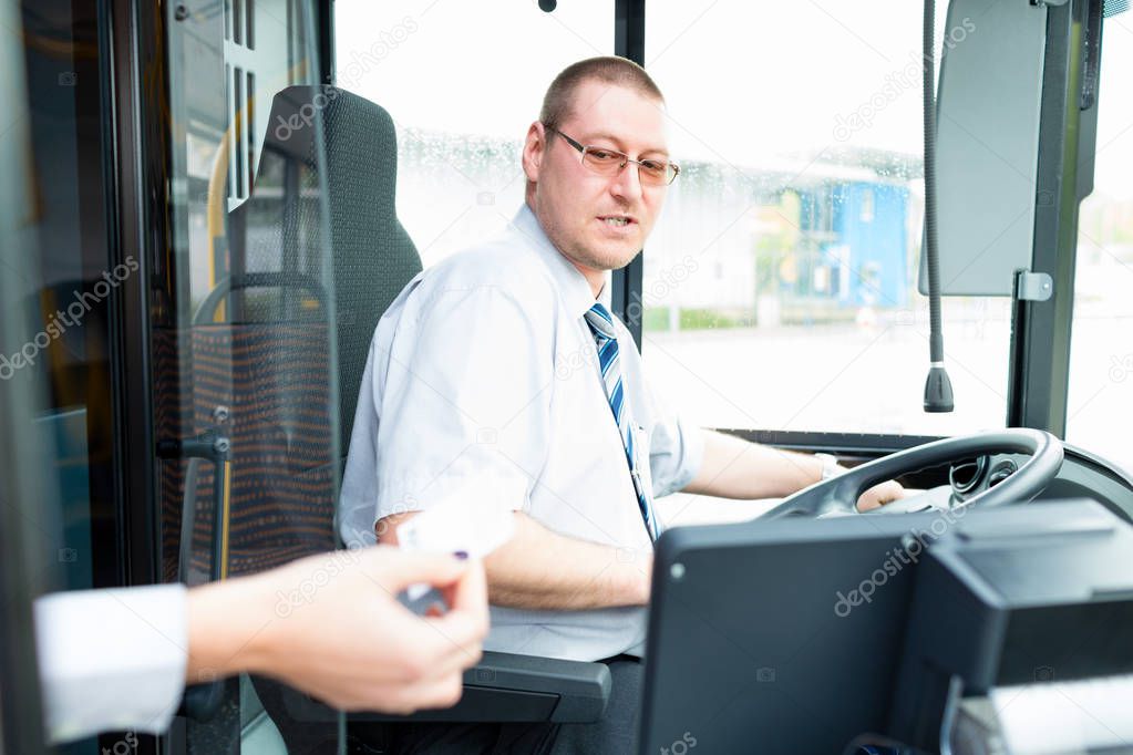 Bus driver selling tickets in bus