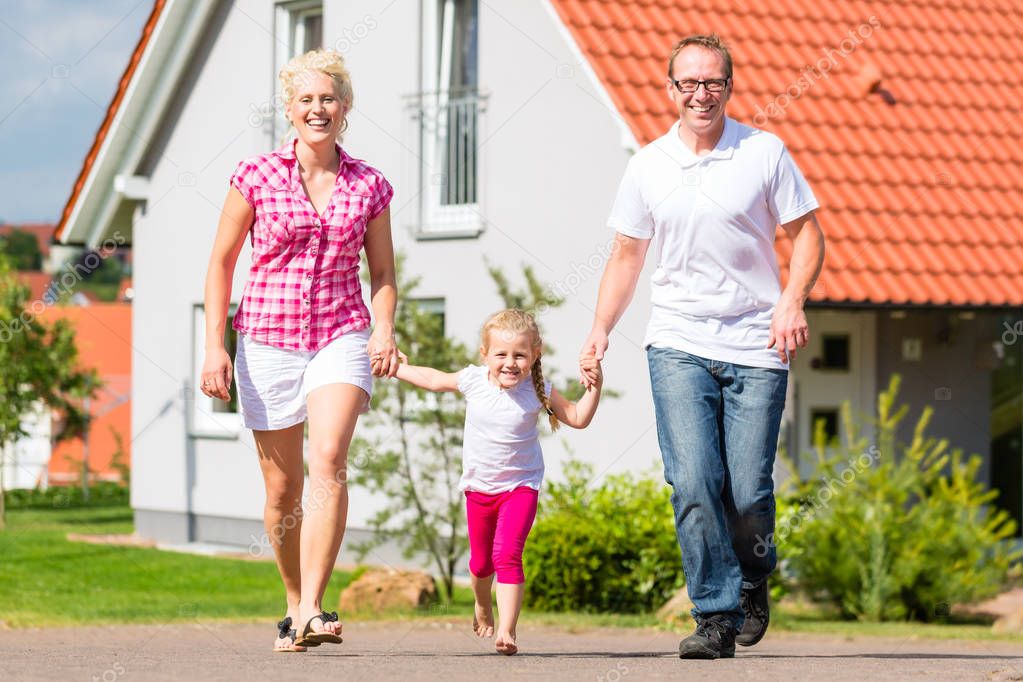 Family taking walk in front of home