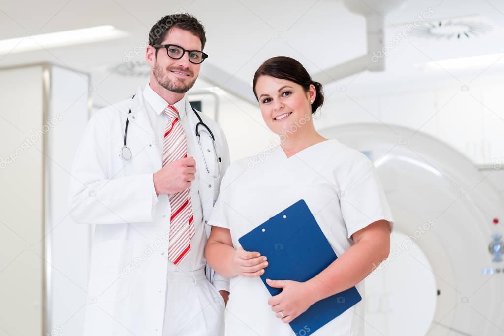 Doctor and nurse in front of CT scan machine