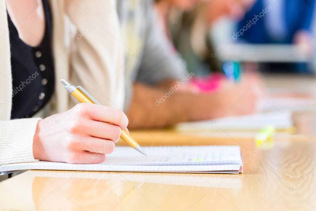 College students writing test or exam