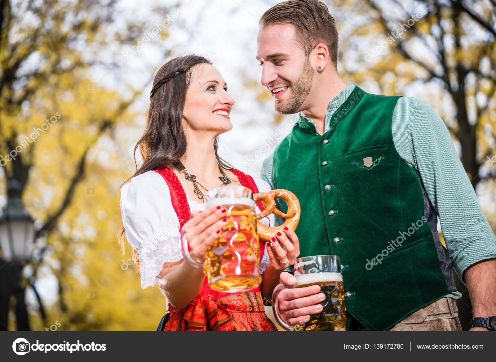 Couple In Dirndl And Tracht Having Pretzel And Bier Stock Photo C Kzenon