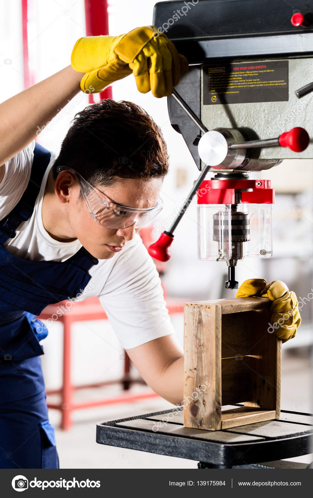 Worker on drilling machine in Stock Photo by ©Kzenon 139175984