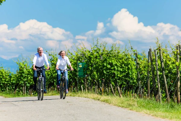 Старша жінка і чоловік, використовуючи велосипед — стокове фото