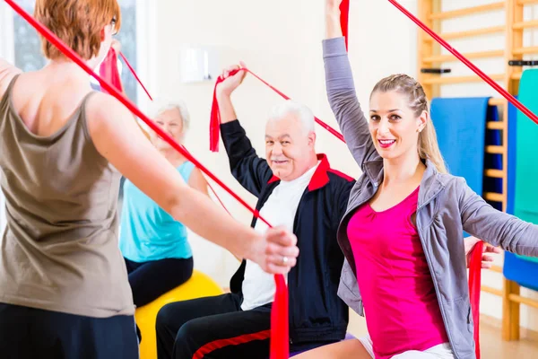 Senior mensen op fitness course in gym — Stockfoto
