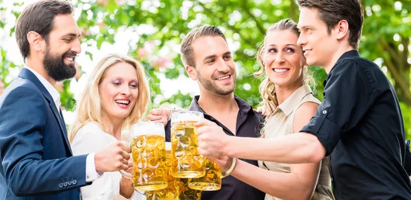 Friends or colleagues on beer garden after work — Stock Photo, Image