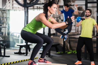 Group of men and woman in functional training gym clipart